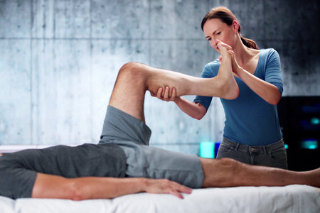 Masseur Giving Leg Massage To Man In Spa Saloonの写真素材