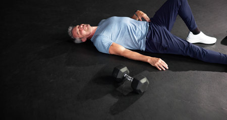 Tired Fit Man After Gym Training Workout. Athlete Lying Down