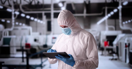 Factory Clean Room Laboratory. Industrial Engineer Using Technologyの写真素材