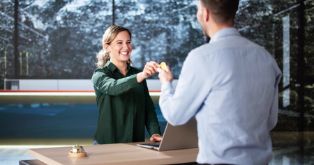 Man At Hotel Talking To Receptionist Woman. Travel Vacation Lifestyleの写真素材