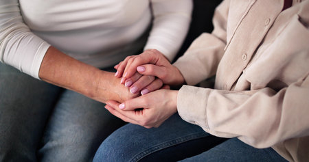 Caregiver Holding Hands Helping Elderly Woman. Retired Family Memberの写真素材