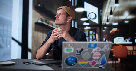 Man Designer With Laptop In Restaurant Or Coffee Shopの写真素材