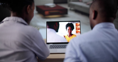 Couple Watching Television Show On Laptop Computer