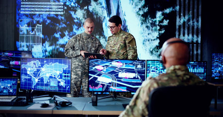 Black Military Operator Monitors CCTV Cameras in High-Tech Control Room