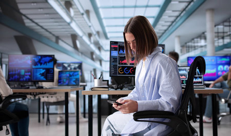 Multicultural Businesswoman Texting on Smartphone During Office Meeting