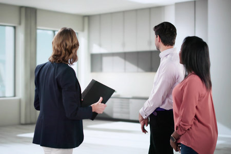Real Estate Agent Shows New Property to Diverse Couple. Renovation Technician Helps Multiracial...