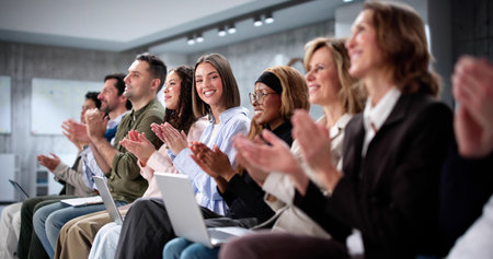 Diverse Team of Business Professionals Applauding in Conference Room Presentation.の写真素材