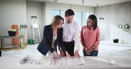 Young Couple Seeking Advice From Realtor in Buying First Homeの写真素材