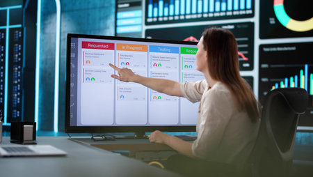 Professional Woman Organizing Project Schedule on Kanban Software Calendar