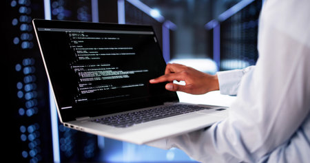 Cloud Computer Engineer Coding In Server Room In Data Center. Configuring AI Technologyの写真素材