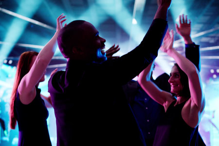 Diverse Group Of People Dancing In Nightclub Under The Lit Sky.の写真素材
