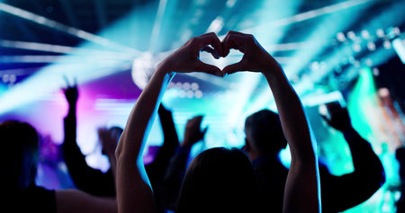 Joyful Fans Dance In Silhouette At Live Heart Concertの写真素材