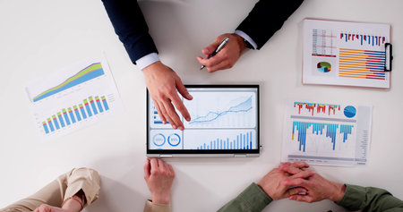 Financial Planner Helping Couple With Tax And Investment Advice In Office.