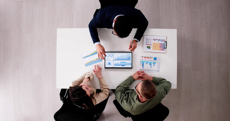 Young Couple Discussing Their Financial Future With A Hispanic Financial Planner