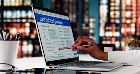 Real Estate Agent Appraising Property While Filling Online Form