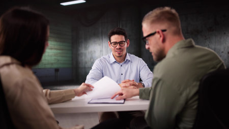 Police Interrogating Suspect In Dark Room During Criminal Investigation Process.の写真素材