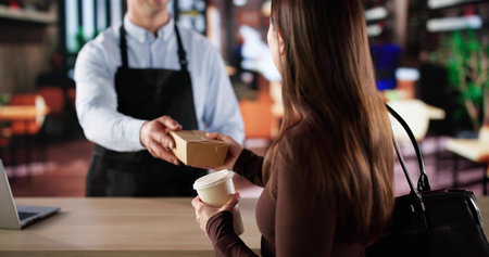 Busy Day At The Cafe. Woman Owner Serving Cappuccino Takeaway To Customers.