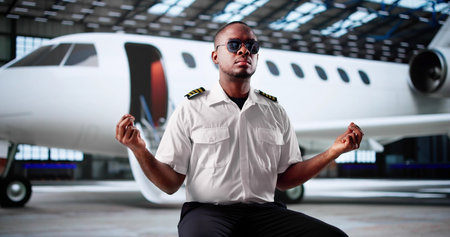 Calm African American Pilot Meditates And Prays Before Flight Departure.の写真素材
