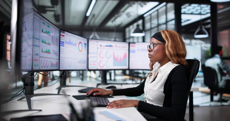 Focused African American Woman Analyzing Stock Market Data On Computerの写真素材