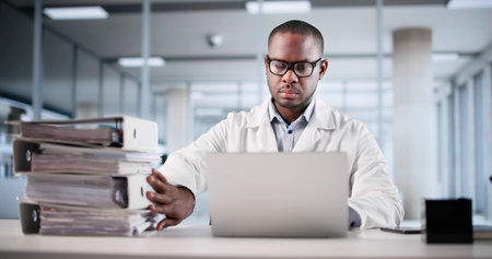 Medical Records Transformation: Young Accountant Digitizing Invoices On Computerの写真素材