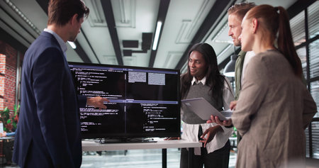 Software Developer Leading Late-Night Meeting With Programmer Team In Office