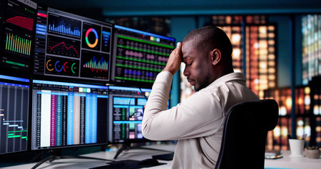Exhausted African American Businessman Working Late At The Office Desk.の写真素材