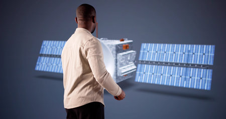 Young Engineer Using 3D CAD Software To Design Satellite Model.