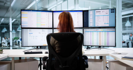 Financial Analyst Conducts Medical Audit On Company Invoices Using Computer