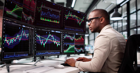 African Broker Utilizes Multiple Screens To Control Financial Transactions Online.