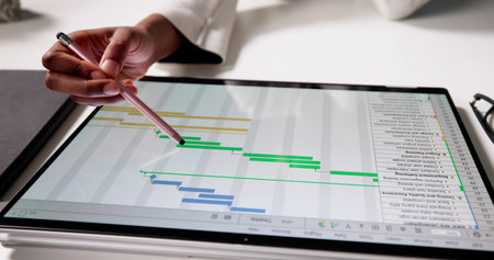 Businesswoman Analyzing Data Chart On Laptop For Finance Project Report.の写真素材