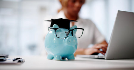 Student Uses Laptop To Save Money For University Education Graduationの写真素材