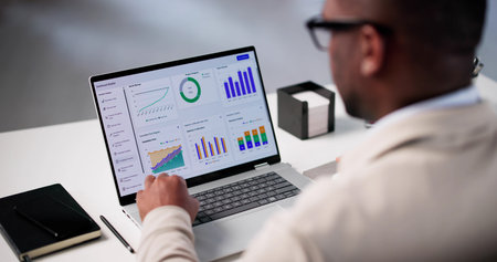 Analyzing Market Trends: Young African American Data Analyst At Workの写真素材