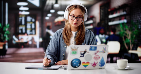 Busy Female Designer Typing Away On Her White Laptop, Online.の写真素材