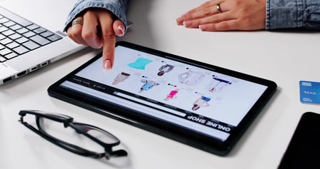 Modern Woman Shopping Online For Trendy Clothes With Credit Cardの写真素材