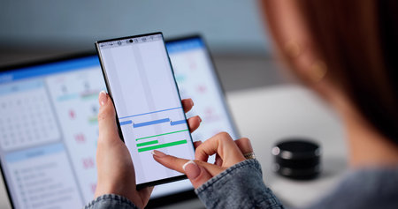 Employee Using Mobile App To Manage Business Schedule And Tasks