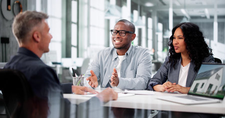 Professional Couple Discussing House Leasing With Diverse Real Estate Agent.の写真素材