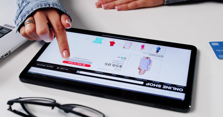 Modern Woman Shopping At Online Fashion Store Using Digital Tabletの写真素材