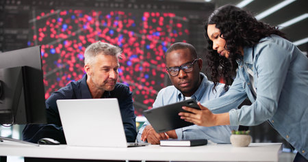 Diverse Cyber Security Team Monitoring Data In Professional Office Setting.の写真素材