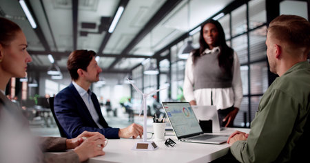 Diverse Corporate Team Discusses Sustainable Energy Strategy At Windfarm Site.の写真素材
