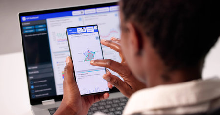 African American Woman Analyzes Stock Market Trends On Smartphone Dashboard