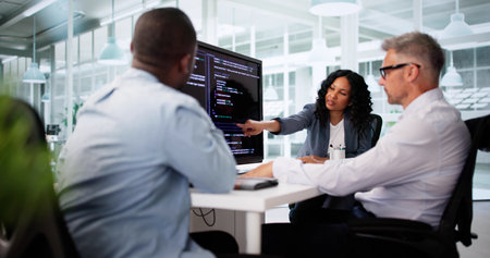 Black Software Engineer Debugs Code On Office Computer Screen.