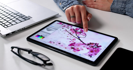 Young Woman Edits Photos On Her Computer For Graphic Design.l