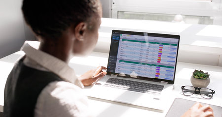 Professional African-American Woman Using Laptop To Analyze Medical Data