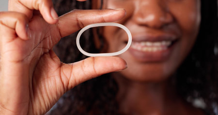 Young African-American Woman Consulting Doctor About Contraceptive Birth Control Options.の写真素材