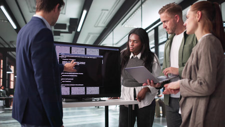 Innovative Developer Guides Team Through Coding Presentation On Big Screen.