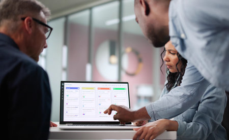 Busy Business Analyst Uses Software To Plan Multiracial Team's Schedule.