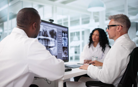 Diverse Group Of Doctors Using Dental Xray Software Together.