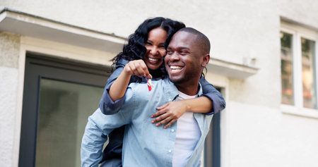 Newly Married Couple Celebrates Buying First Home, Holding Shiny Keys.の写真素材