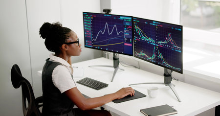 African Woman Broker Monitoring Trading Market Using Multiple Computer Screens