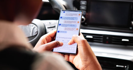 Texting While Driving: Distraction In Car Poses Serious Dangers.の写真素材